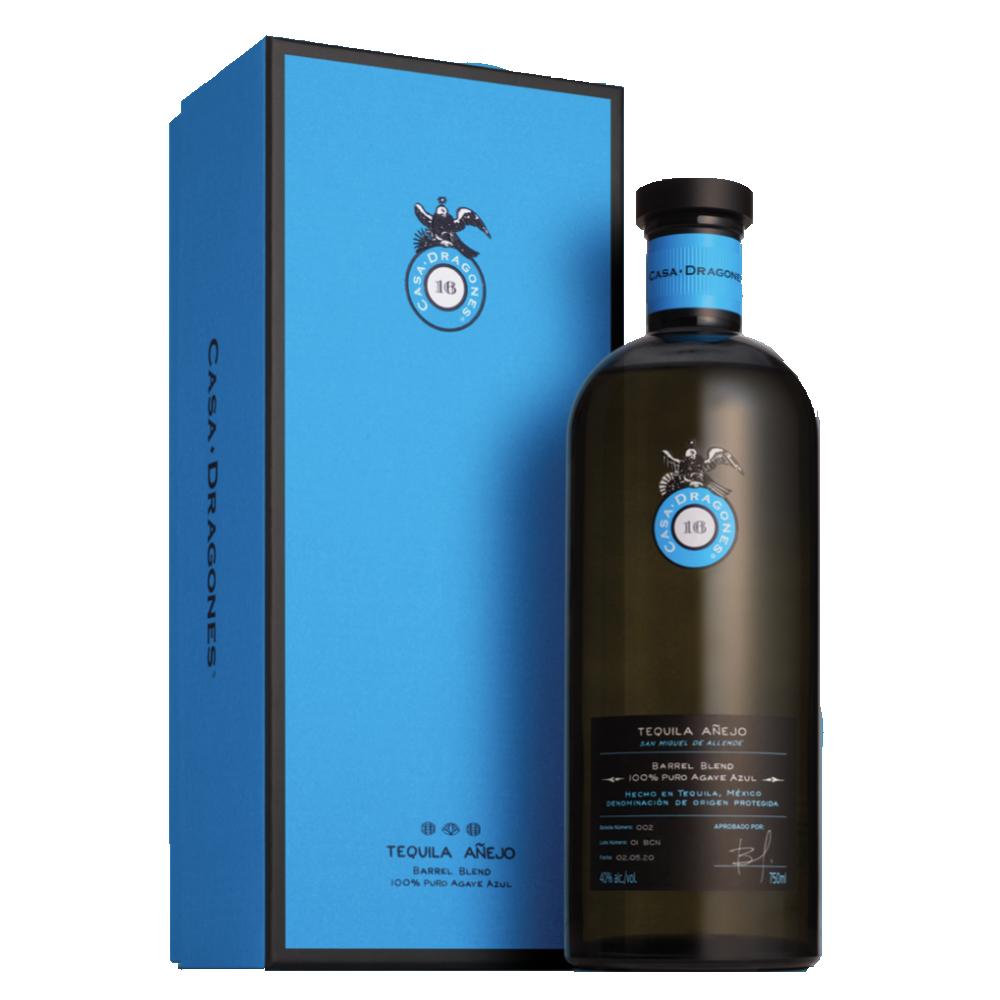 Añejo tequila bottle with black cap and blue presentation box, amber glass