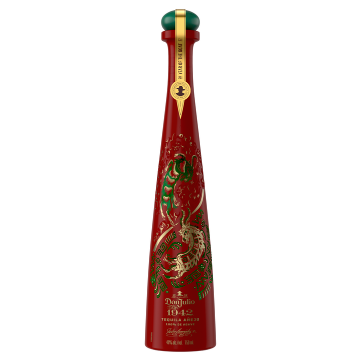 Don Julio 1942 tequila anejo bottle, red with green dragon artwork and gold badge