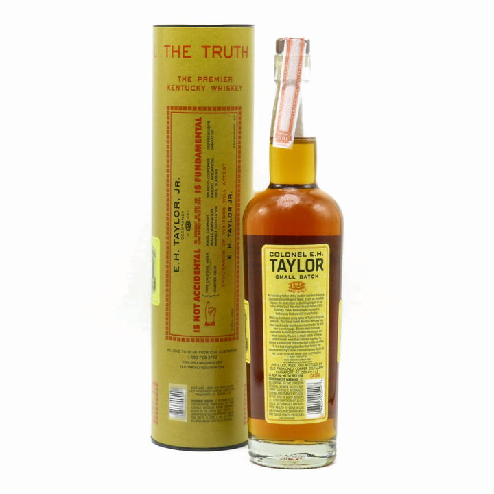 Small-batch bourbon whiskey bottle with back label, gold liquid, with matching carton