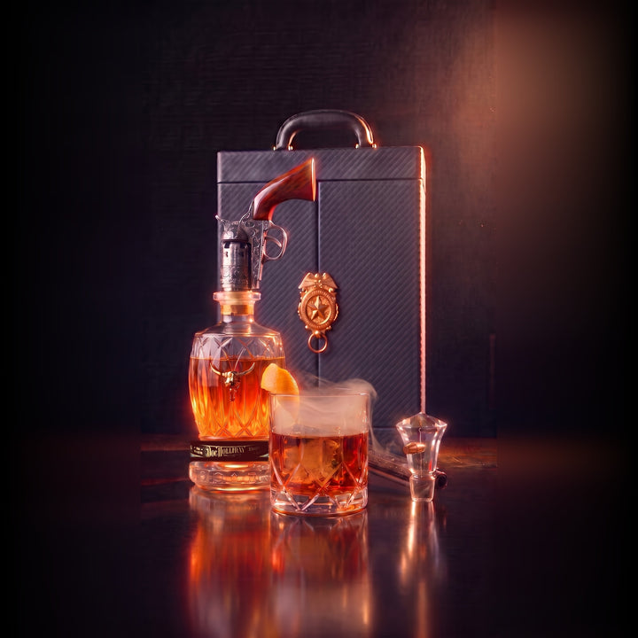 Doc Holliday bourbon whiskey set, amber bottle with revolver accessory and glass cup