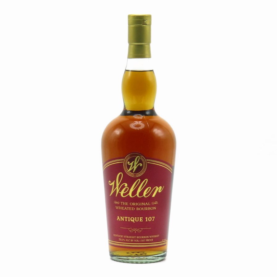 Bourbon whiskey bottle with gold cap and amber glass, front label facing camera